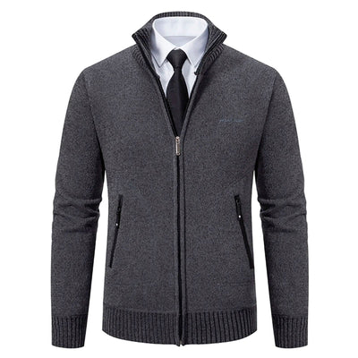 Gray zip-up sweater over a white shirt with a black tie on a white background